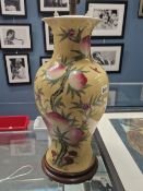 A LARGE ORIENTAL VASE WITH YELLOW GROUND AND FRUIT TREE DECORATION- LATER MOUNTED AS A LAMP.