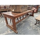 A TEAK AND PINE REFECTORY TABLE WITH A CLEATED PLANK TOP AND ON PAIRS OF LEGS TO EACH NARROW