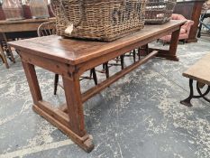 A TEAK AND PINE REFECTORY TABLE WITH A CLEATED PLANK TOP AND ON PAIRS OF LEGS TO EACH NARROW