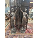 A PAIR OF BRONZE FIGURAL STANDARD LAMPS, EACH TORCH SHAPE HELD UP BY A SCANTILY DRAPED CLASSICAL