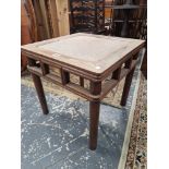 A CHINESE HARDWOOD TABLE, THE CANE INSET TOP ABOVE AN OPEN WORK APRON AND FOUR CYLINDRICAL LEGS.   W