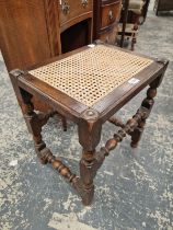 A CANED OAK STOOL TOGETHER WITH TWO FOOTSTOOLS WITH NEEDLE WORK SEATS