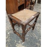 A CANED OAK STOOL TOGETHER WITH TWO FOOTSTOOLS WITH NEEDLE WORK SEATS