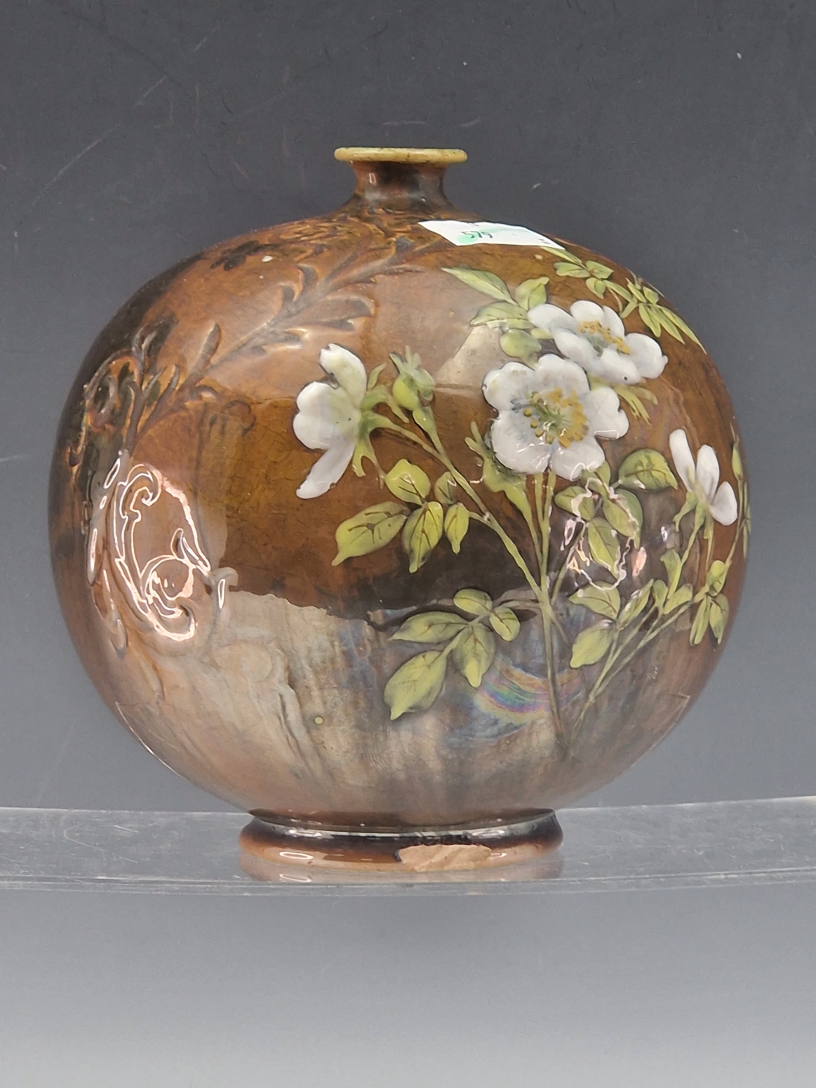 A DOULTON COMPRESSED SPHERICAL VASE PAINTED WITH WHITE AND YELLOW BLOSSOMS FLOWERING ON A STREAKY