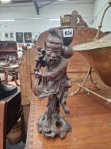 A CHINESE CARVED WOOD FIGURE OF A DAOIST IMMORTAL AS A TABLE LAMP