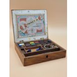 A LATE VICTORIAN ROWNEY MAHOGANY PAINT BOX CONTAINING UNUSED BLOCKS OF PAINT, A PALETTE AND A