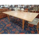 A LARGE ARTS AND CRAFTS INSPIRED OAK REFECTORY TABLE ON SQUARE TAPERED LEGS.