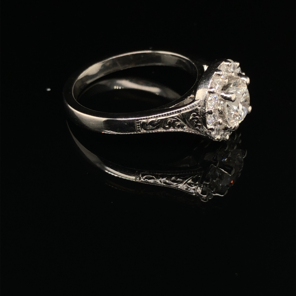 A GIA ROUND BRILLIANT CUT DIAMOND AND PLATINUM RING. THE CENTRE DIAMOND 0.71cts, SURROUNDED BY A - Image 3 of 10