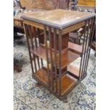 AN EARLY 20th C. MAHOGANY ROTARY BOOKCASE, A SATIN WOOD BAND TO THE TOP ENCLOSING A FOLIATE