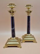 A PAIR OF RED MARBLE AND ORMOLU CANDLESTICKS, THE TWO HANDLED URN NOZZLES ABOVE CORINTHIAN CAPITALS,