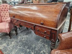 A 19th C. MAHOGANY ROLL TOP DESK WITH A CONFIGURATION OF FIVE DRAWERS ABOVE THE CYLINDRICAL LEGS