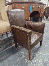 A CHILDS BROWN LEATHERETTE UPHOLSTERED ARM CHAIR ON SQUARE SECTION MAHOGANY LEGS