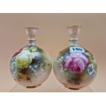 A PAIR OF 1911 ROYAL WORCESTER VASES, THE COMPRESSED SPHERICAL BODIES PAINTED WITH ROSES. H 15.5cms.