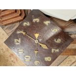 AN ARTS AND CRAFTS WALL CLOCK WITH APPLIED BRASS NUMERALS.