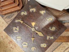 AN ARTS AND CRAFTS WALL CLOCK WITH APPLIED BRASS NUMERALS.