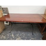 A STAINED WOOD CLEATED PLANK TOP RECTANGULAR REFECTORY TABLE ON CURVED IRON LEGS. W 183 x D 102 x