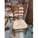 A SET OF SIX OAK LADDER BACK CHAIRS WITH RUSH DROP IN SEATS