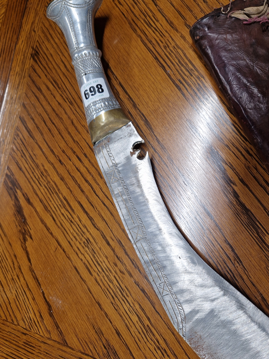 A KUKRI IN A LEATHER SCABBARD, THE HANDLE OF ALUMINIUM, THE OVERALL LENGTH. 73cms. - Image 4 of 6