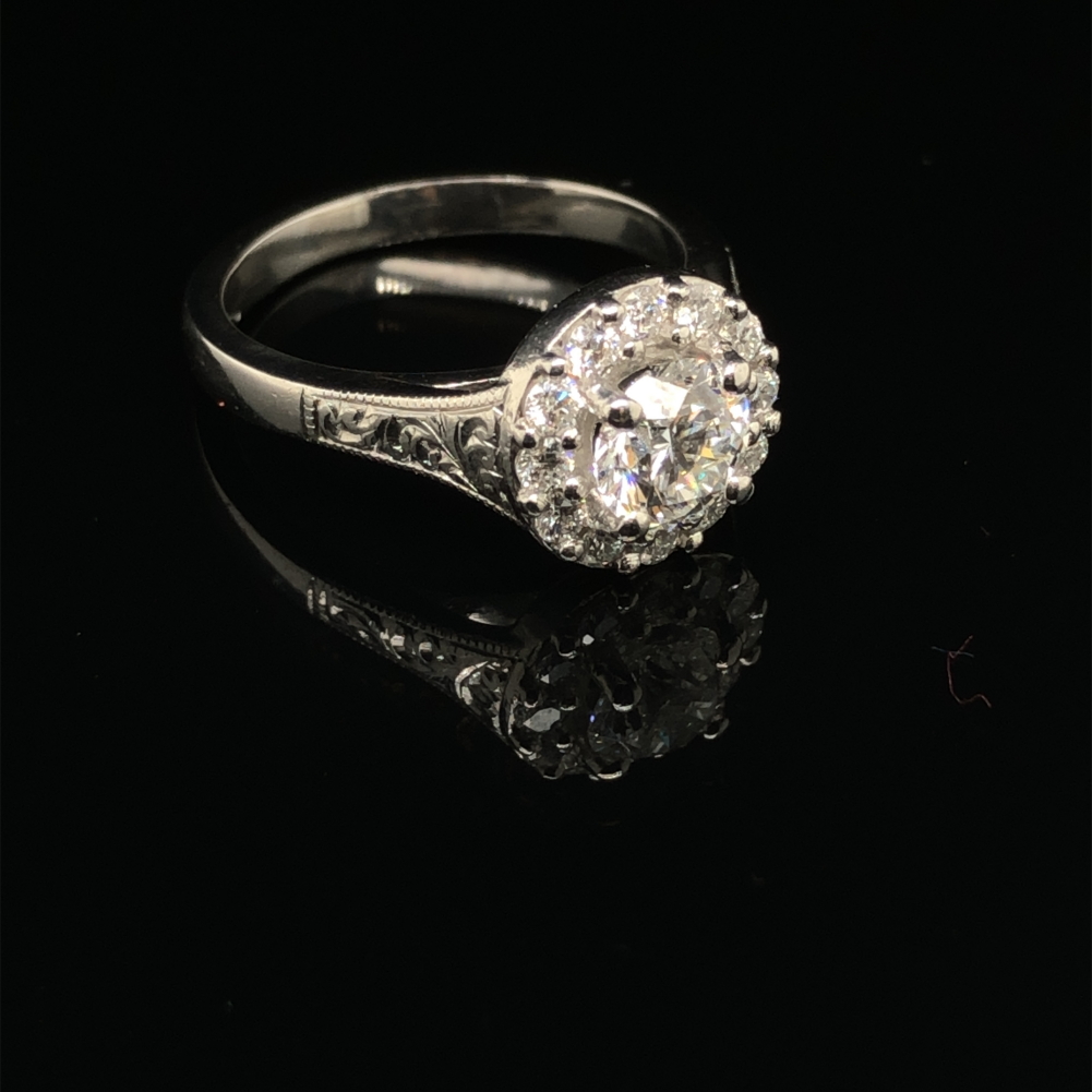 A GIA ROUND BRILLIANT CUT DIAMOND AND PLATINUM RING. THE CENTRE DIAMOND 0.71cts, SURROUNDED BY A - Image 7 of 10