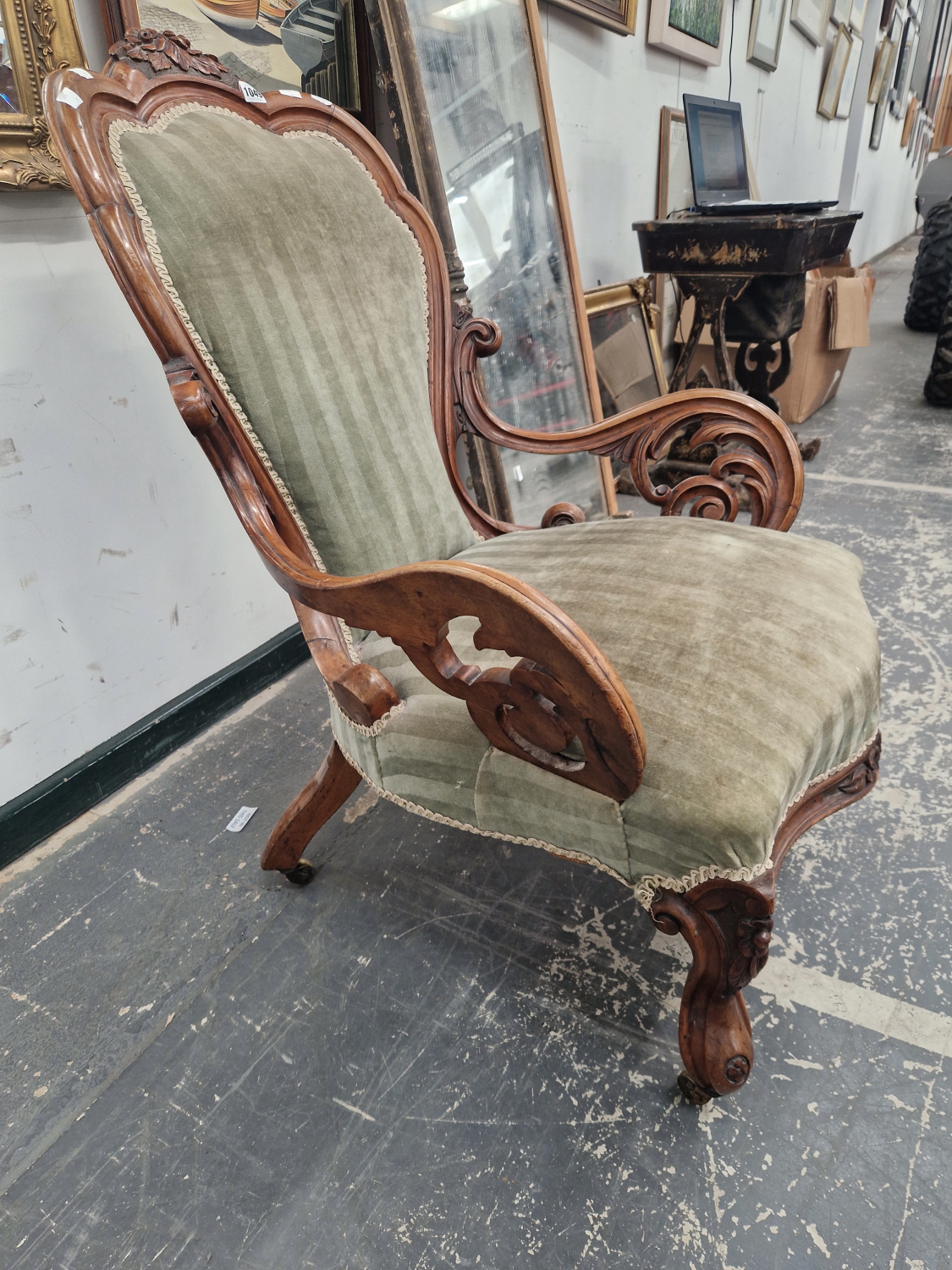 A VICTORIAN WALNUT SHOW FRAME ARMCHAIR CRESTED BY A PAIR OF CARVED FLOWER HEADS THE ARMS SUPPORTED - Image 2 of 3