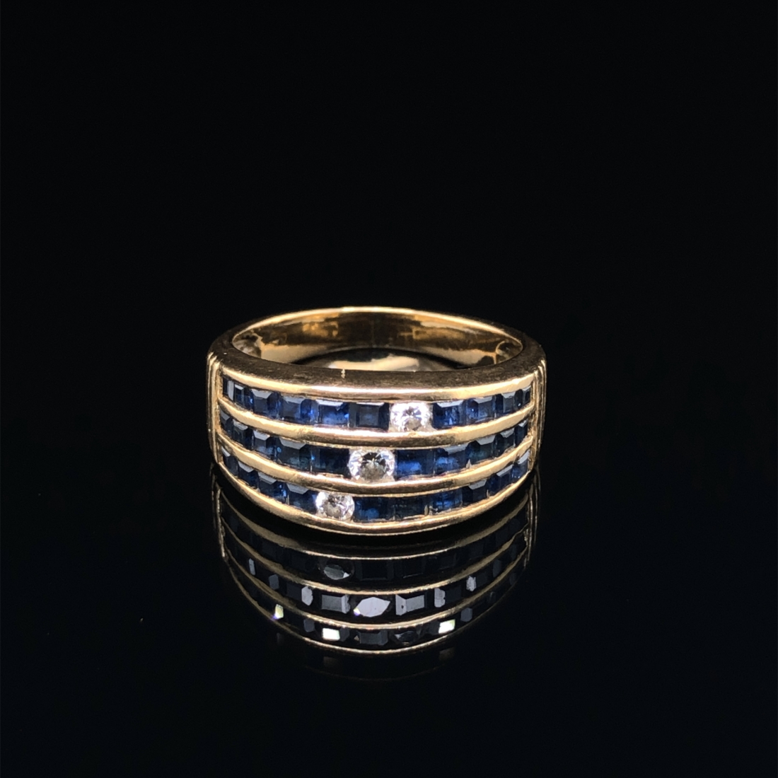 A SAPPHIRE AND DIAMOND THREE ROW CHANNEL SET HALF HOOP RING. UNHALLMARKED, ASSESSED AS 18ct GOLD. - Image 2 of 7