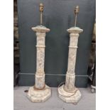 A PAIR OF PINK TINGED MOTTLED ALABASTER LAMPS, THE CYLINDRICAL COLUMNS RAISED ON OCTAGONAL FEET. H
