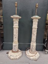 A PAIR OF PINK TINGED MOTTLED ALABASTER LAMPS, THE CYLINDRICAL COLUMNS RAISED ON OCTAGONAL FEET. H