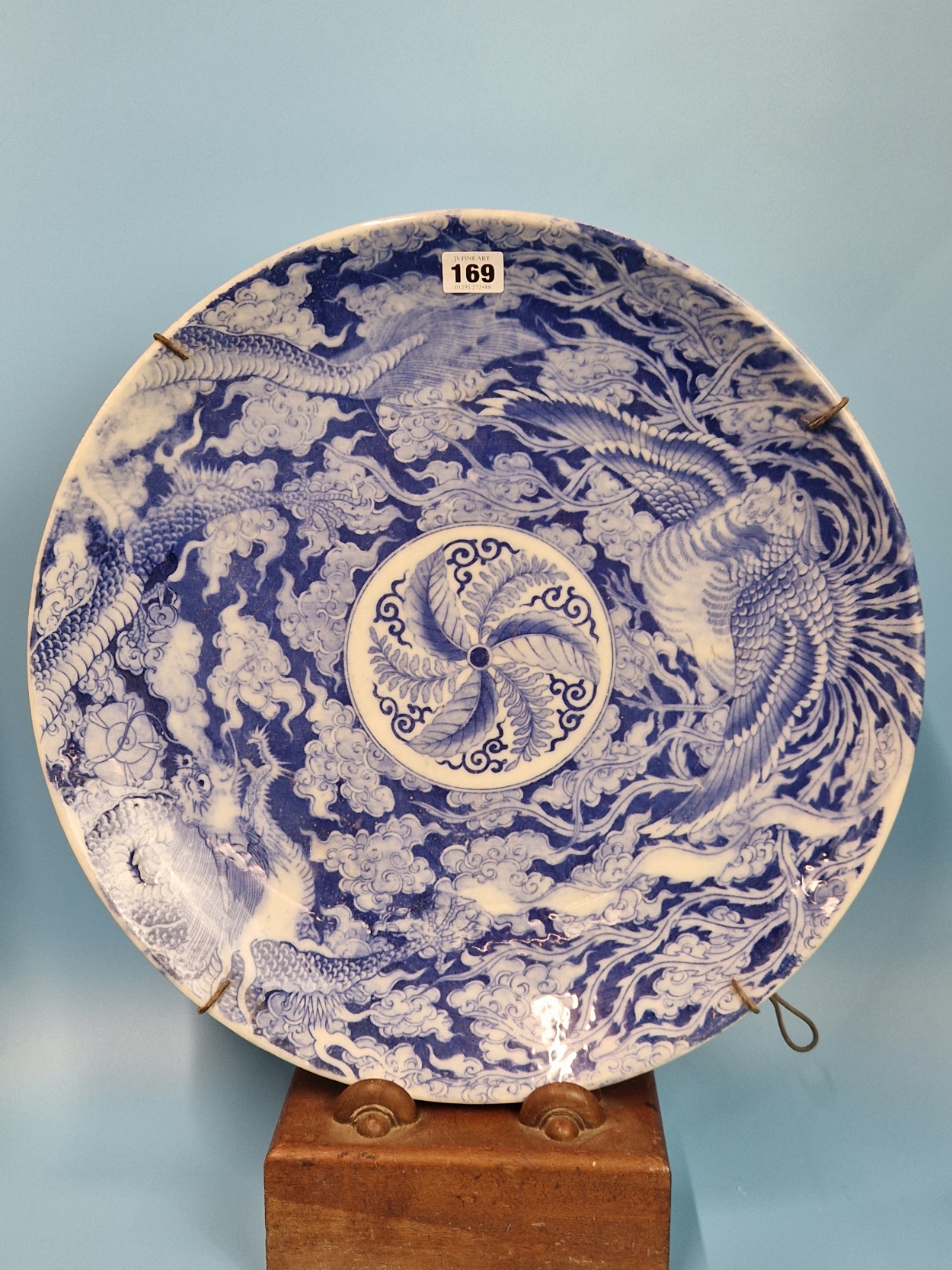 A PAIR OF JAPANESE BLUE AND WHITE CHARGERS PRINTED WITH DRAGONS AND PHOENIX ENCLOSING ROSETTES. Dia.