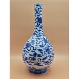 A CHINESE BLUE AND WHITE BOTTLE VASE PAINTED WITH RIBBON TIED PRECIOUS OBJECTS AMONGST CLOUDS. H