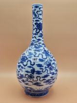 A CHINESE BLUE AND WHITE BOTTLE VASE PAINTED WITH RIBBON TIED PRECIOUS OBJECTS AMONGST CLOUDS. H