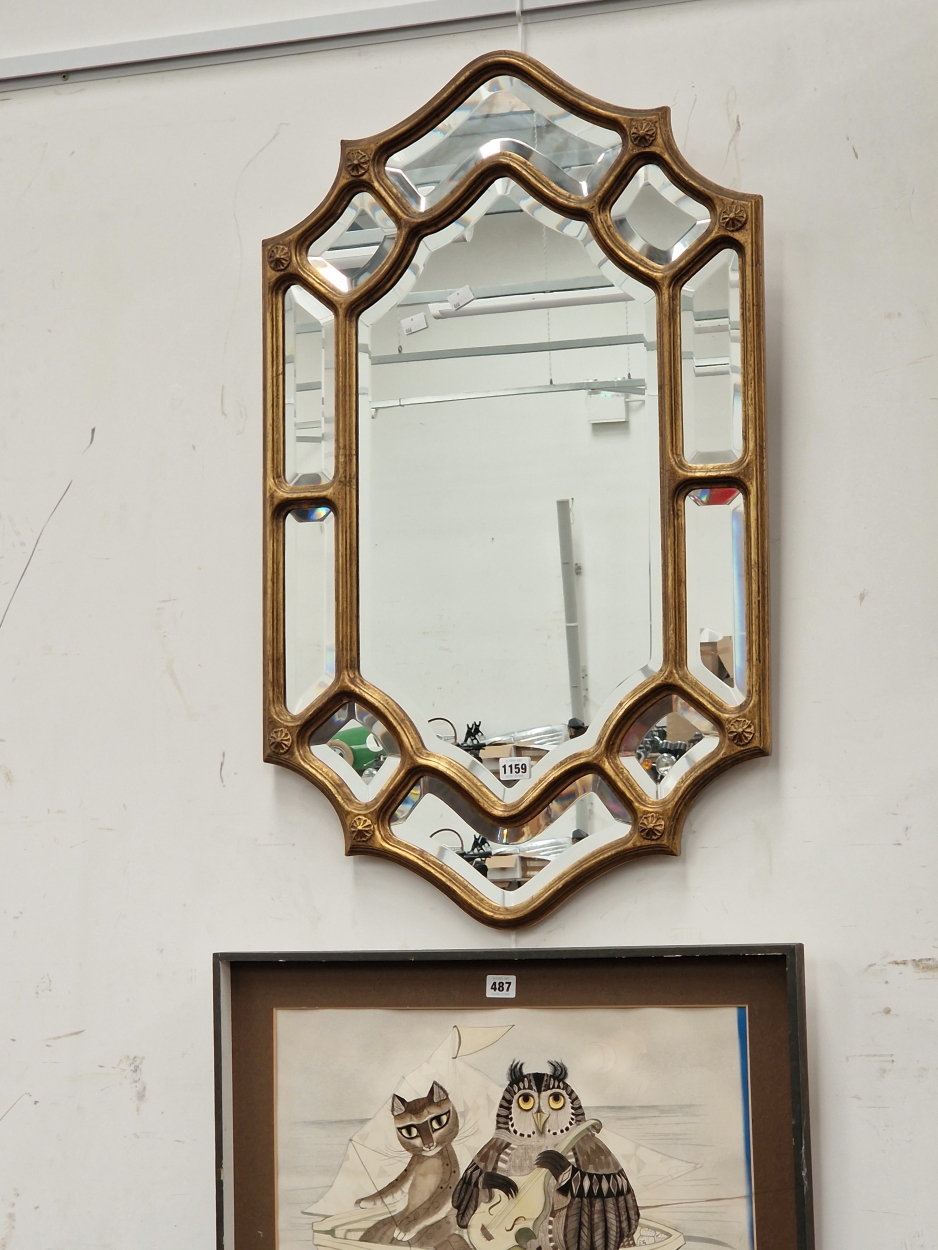 A VINTAGE WALL MIRROR WITH MULTI PLATE BORDER.