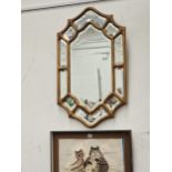 A VINTAGE WALL MIRROR WITH MULTI PLATE BORDER.