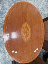AN EDWARDIAN INLAID AND CROSS BANDED OAVAL OCCASIONAL TABLE WITH LOWER TIER.
