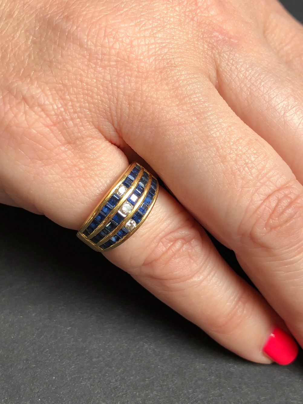 A SAPPHIRE AND DIAMOND THREE ROW CHANNEL SET HALF HOOP RING. UNHALLMARKED, ASSESSED AS 18ct GOLD. - Image 5 of 7
