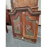 A SCANDINAVIAN PAINTED PINE OF TWO DOORS ABOVE A DRAWER, EACH PAINTED WITH STYLISED FLOWERS