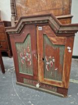 A SCANDINAVIAN PAINTED PINE OF TWO DOORS ABOVE A DRAWER, EACH PAINTED WITH STYLISED FLOWERS