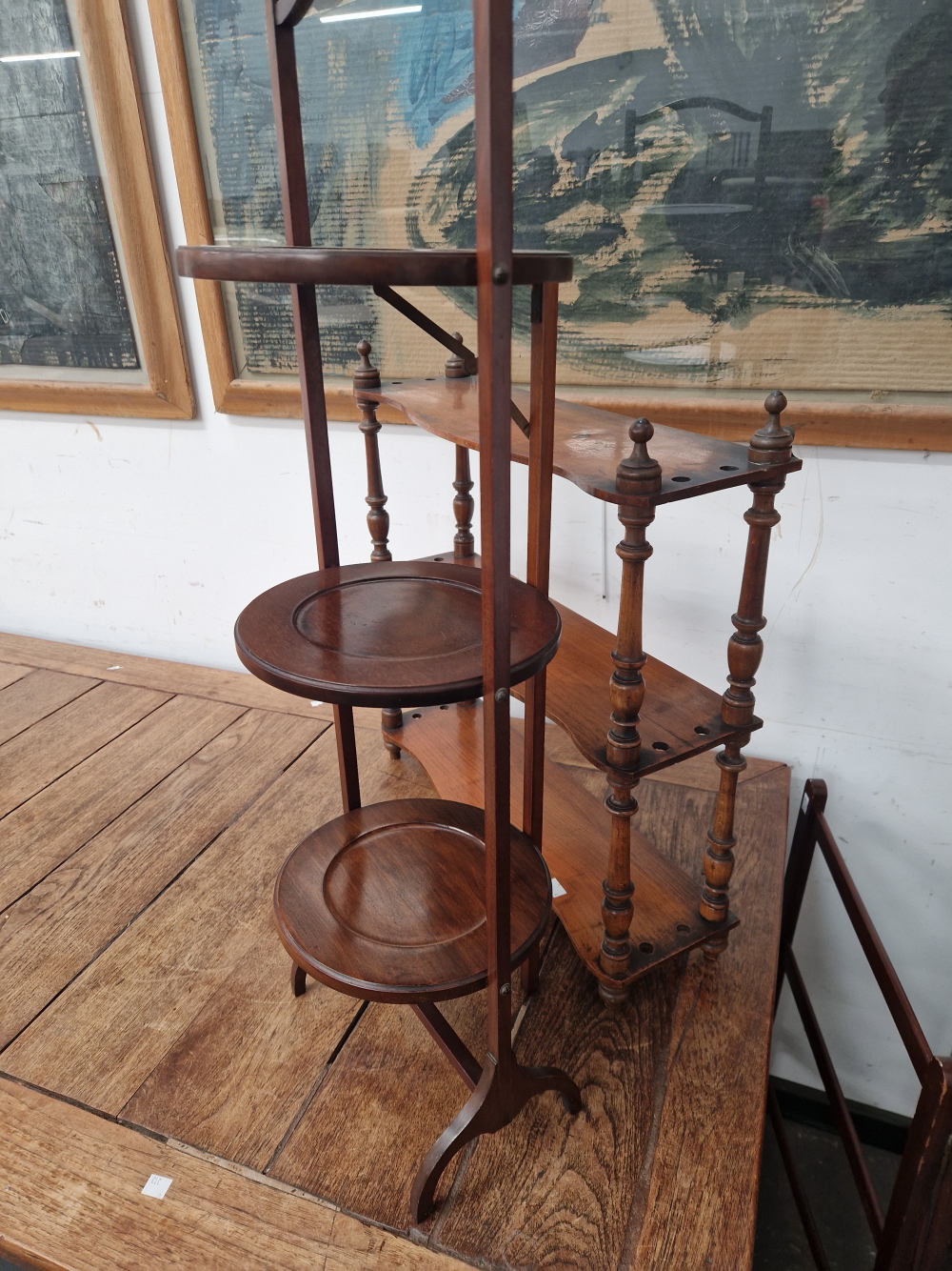 A MAHOGANY THREE TIER FOLDING CAKE STAND, A TOWEL RAIL AND A THREE SHELF WALL UNIT