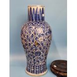 A CHINESE BLUE AND WHITE BALUSTER VASE PAINTED WITH SCROLLING LOTUS BETWEEN STIFF LEAF AND LAPPET