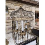 A THREE CANDLE SOCKET CEILING LIGHT WITHIN A PARCEL GILT WIRE WORK BIRD CAGE SHADE. H 65cms.