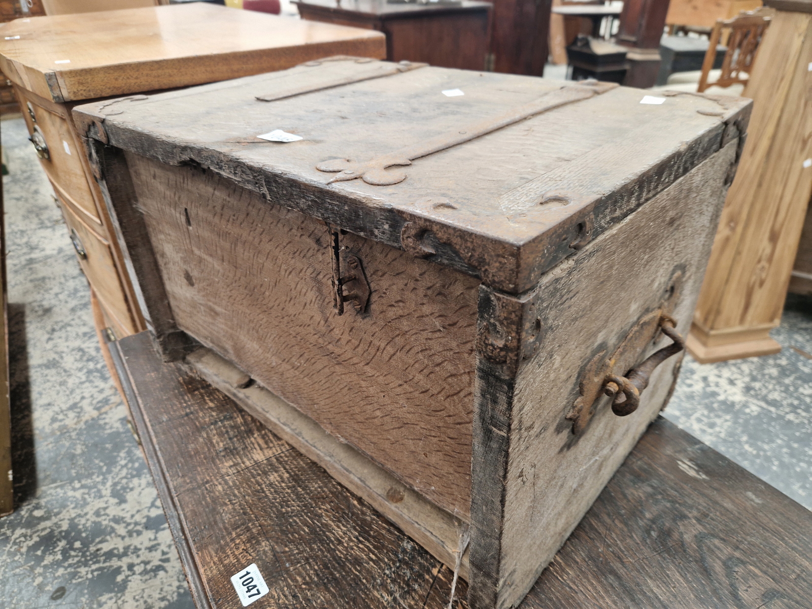 AN IRON BOUND TWO HANDLED OAK STRONG BOX BEARING THE DATE 1689 INSIDE THE HINGED LID