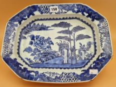 AN 18th C. CHINESE BLUE AND WHITE PLATTER CENTRALLY PAINTED WITH BAMBOO, ROCKS AND A PEONY ON AN