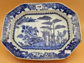 AN 18th C. CHINESE BLUE AND WHITE PLATTER CENTRALLY PAINTED WITH BAMBOO, ROCKS AND A PEONY ON AN