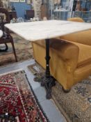 A WHITE MARBLE TOPPED IRON TABLE, THE SQUARE TOP ON A COLUMN WITH TRIPARTITE FOOT. W 61 x D 61 x H