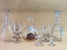 TWENTY RUMMER AND PUB TYPE GLASSES TOGETHER WITH TWO DECANTERS AND A CARAFE WITH A RUBY DOMED