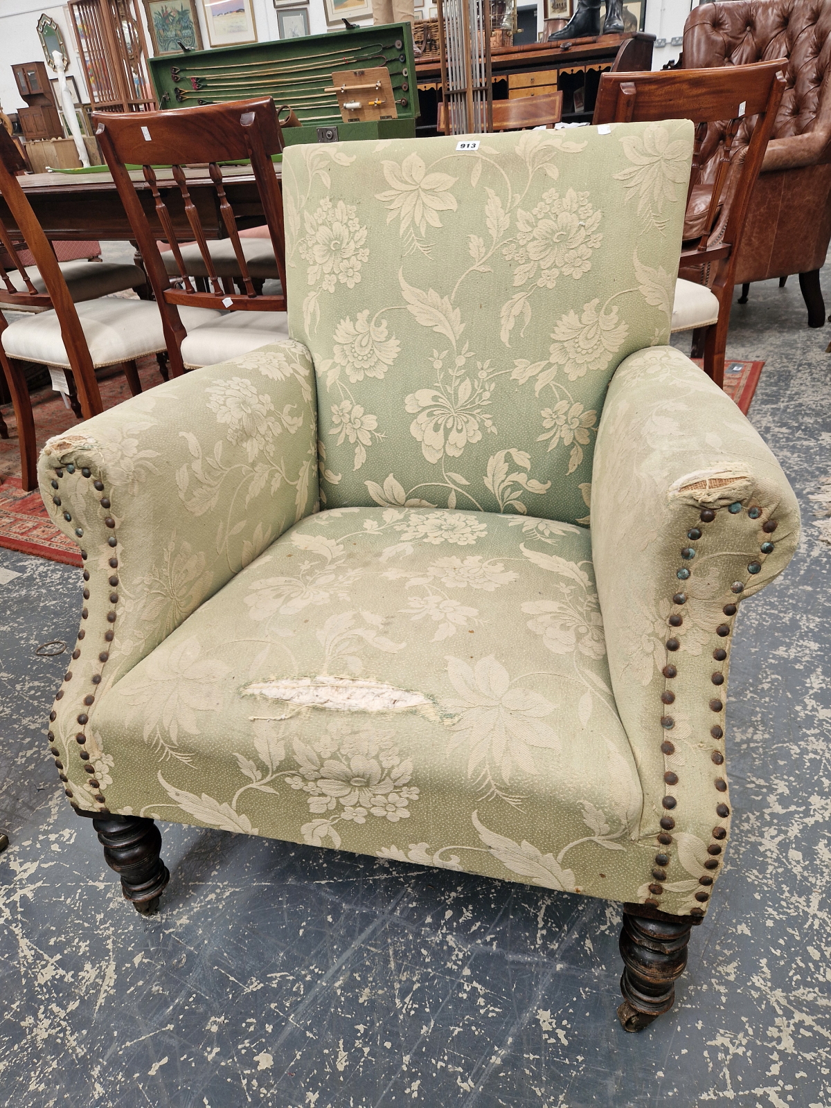 A VICTORIAN MAHOGANY ARMCHAIR, THE TURNED FRONT LEGS ON IRON CASTER FEET