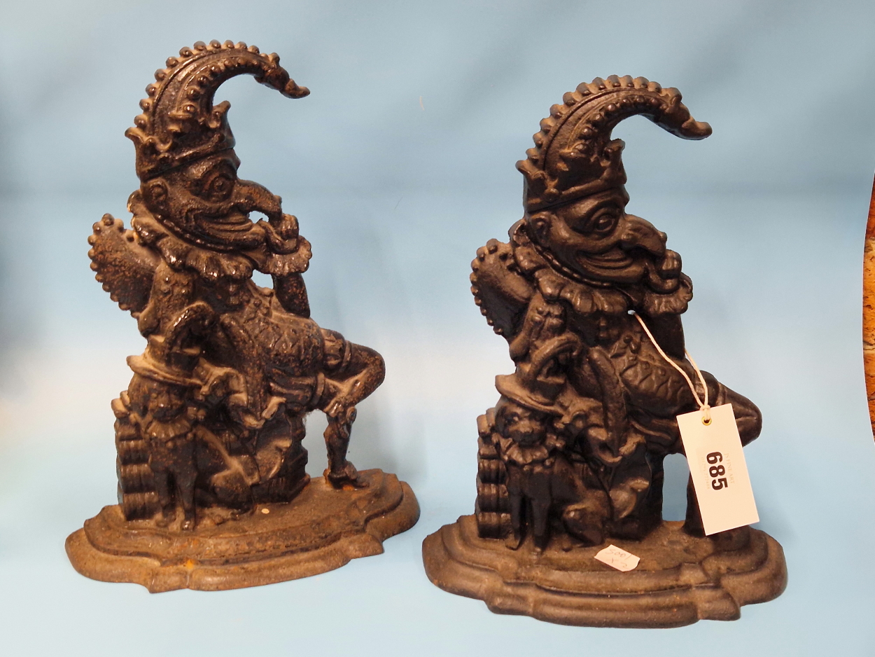 A PAIR OF CAST IRON MR PUNCH AND HIS DOG DOOR STOPS. H 30cms.