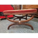 A VICTORIAN MAHOGANY STOOL WITH A FLORAL NEEDLE WORK SEAT, THE CURVED LEGS JOINED BY A CENTRAL
