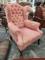 A MAHOGANY WING BACK ARMCHAIR BUTTON UPHOLSTERED IN PINK