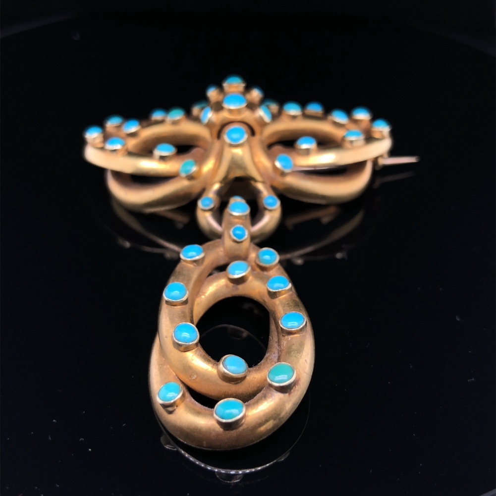 A VICTORIAN TURQUOISE SET LOVERS KNOT BROOCH WITH SERPENTINE STYLE ARTICULATED DROP AND MEMORIAL