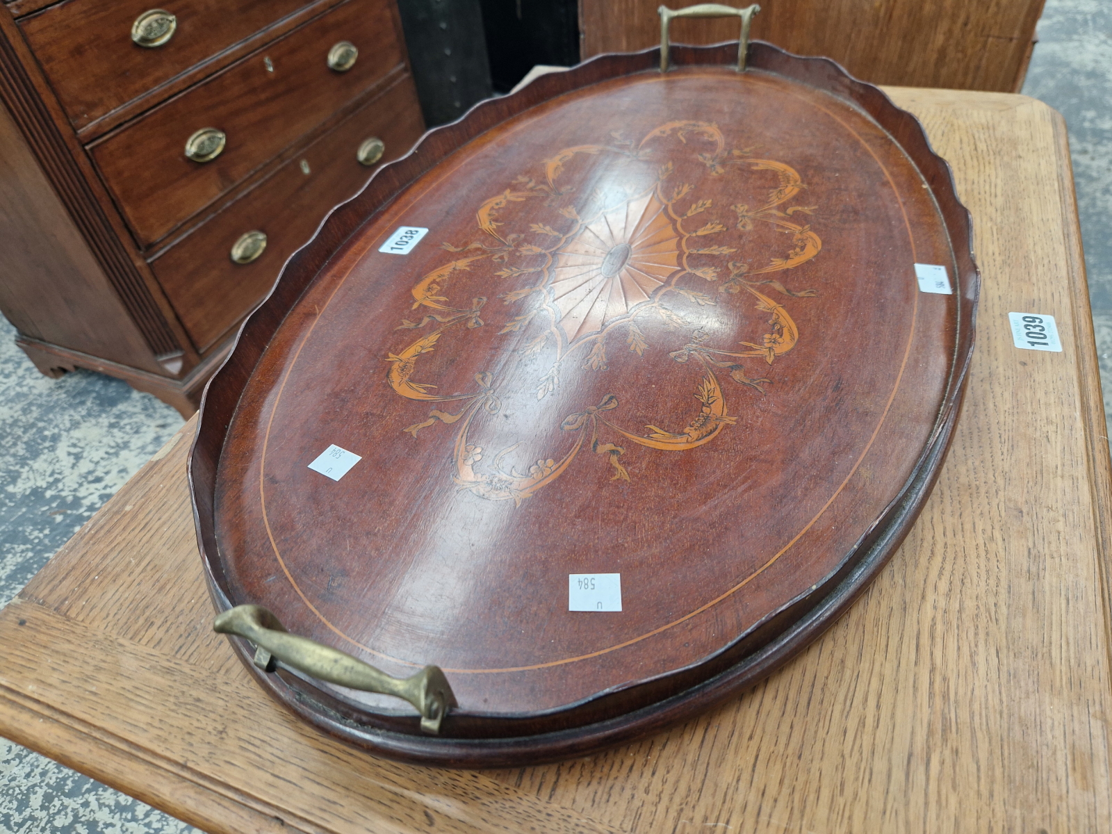 A BRASS HANDLED MAHOGANY OVAL TRAY INLAID WITH A CENTRAL PATERA WITHIN DRAPERY SWAGS - Image 2 of 2